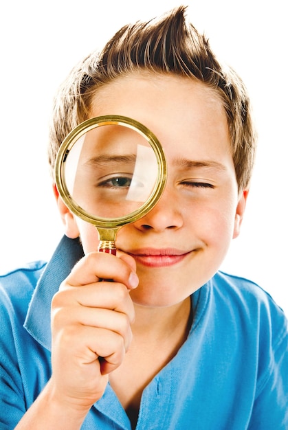 Little boy with magnifier isolated on a white background