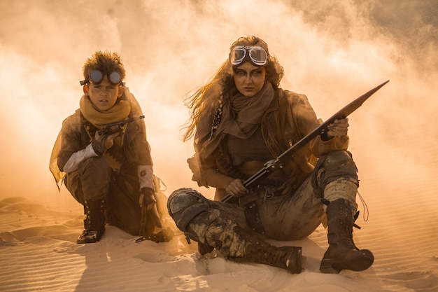 Little boy and woman in post apocalyptic costumes