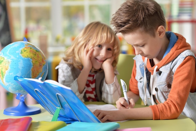 Little boys doing lessons at home in his room