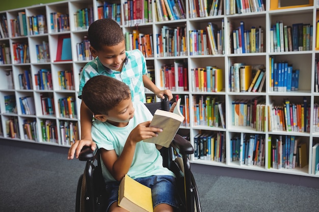 Little boys holding books