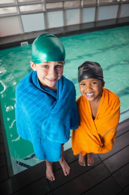 Little boys smiling by the pool