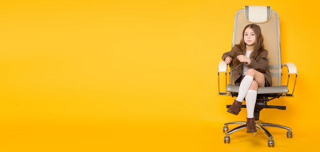 Little brunette girl in chair