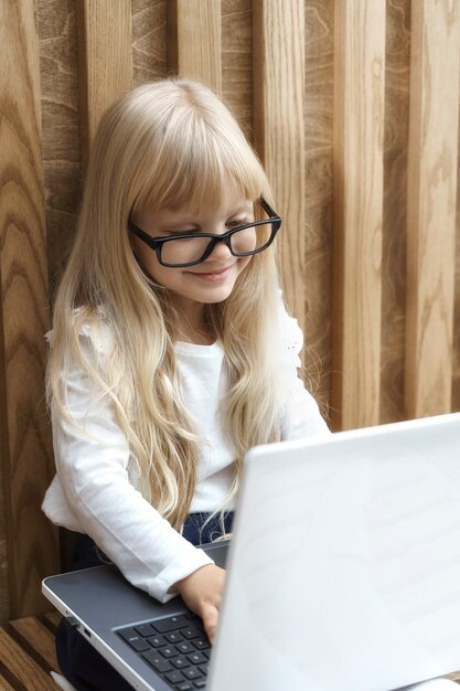 Little businesswoman with laptop working in office