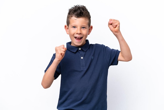 Little caucasian boy isolated on white background celebrating a victory