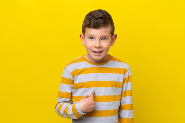 Little caucasian boy isolated on yellow background with surprise facial expression