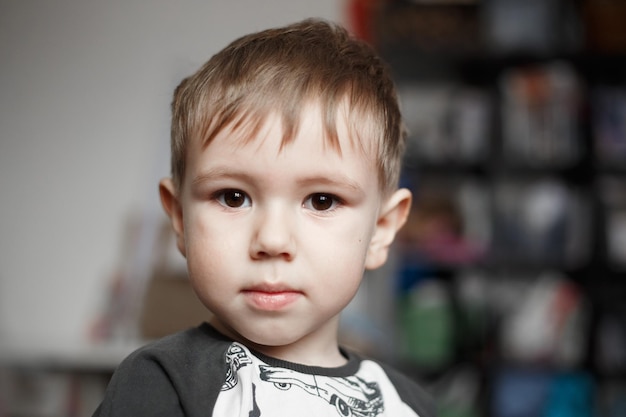 Little Caucasian boy looking at camera, lifestyle photography at home