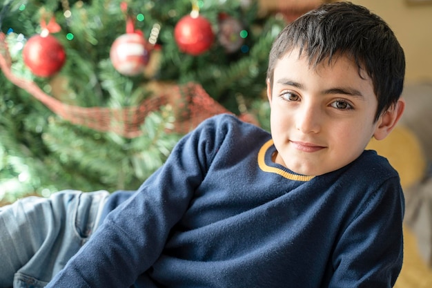 Little caucasian boy relaxed at home in Chritmas mood