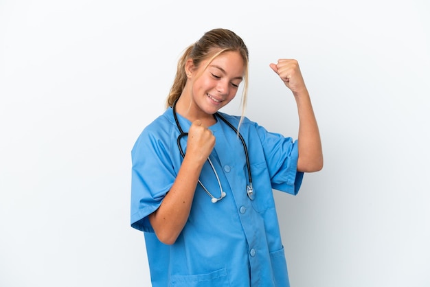 Little caucasian girl disguised as surgeon isolated on white background celebrating a victory