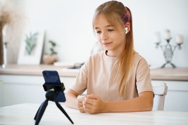 Little caucasian girl having a video call on mobile phone