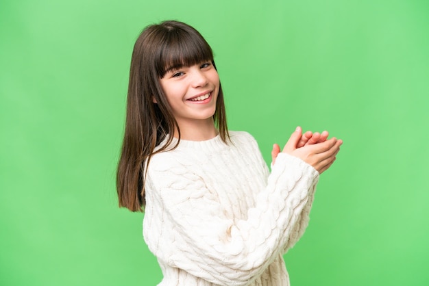 Little caucasian girl over isolated background applauding