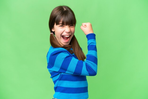 Little caucasian girl over isolated background celebrating a victory