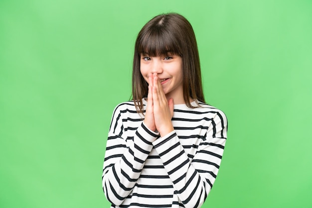 Little caucasian girl over isolated background keeps palm together Person asks for something