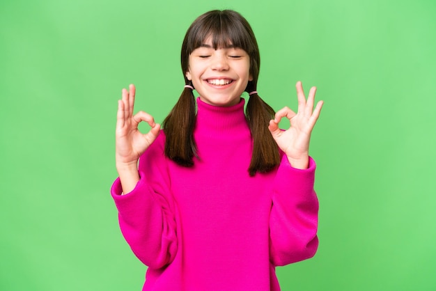 Little caucasian girl over isolated background in zen pose