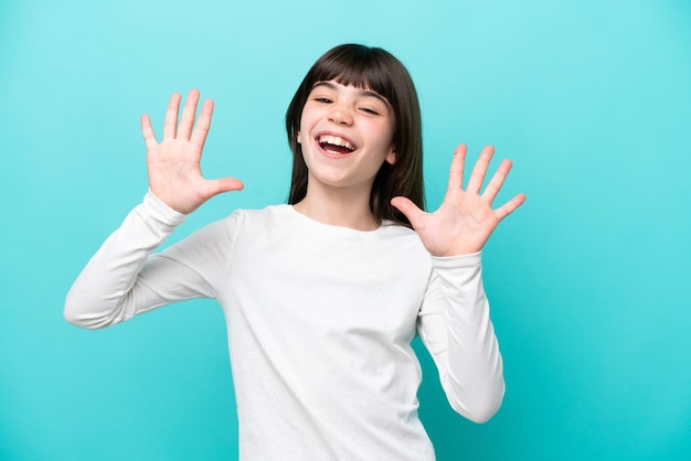 Little caucasian girl isolated on blue background counting ten with fingers