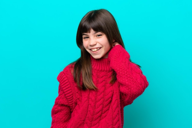 Little caucasian girl isolated on blue background laughing