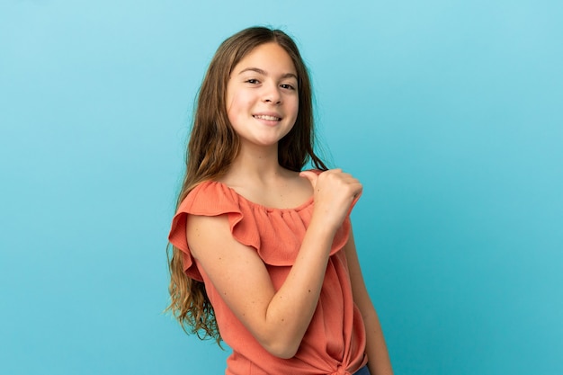 Little caucasian girl isolated on blue background proud and self-satisfied