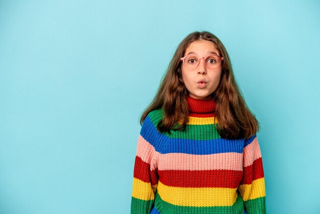 Little caucasian girl isolated on blue background