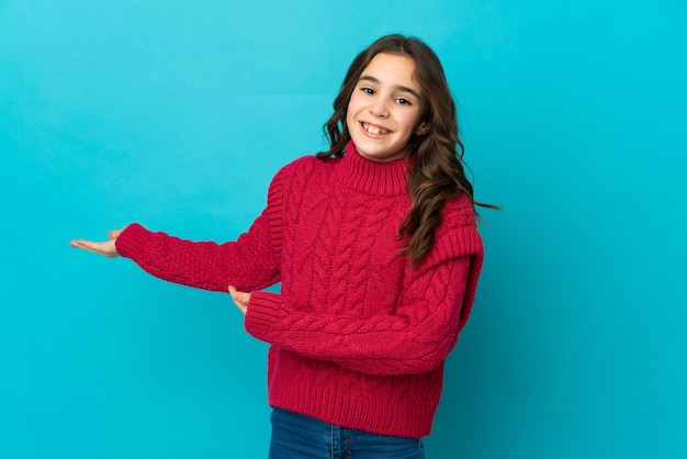 Little caucasian girl isolated extending hands to the side for inviting to come