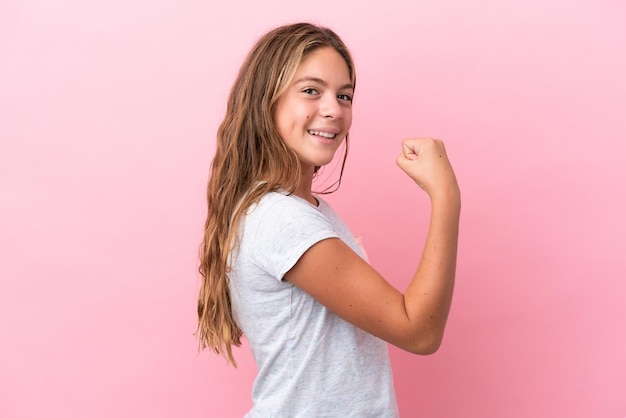 Photo little caucasian girl isolated on pink background celebrating a victory