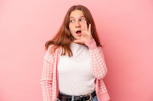 Little caucasian girl isolated on pink background shouting excited to front.