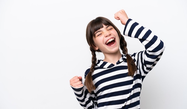 Little caucasian girl isolated on white background celebrating a victory