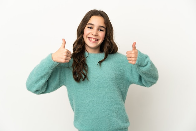 Little caucasian girl isolated on white background giving a thumbs up gesture