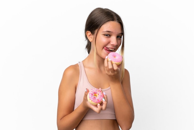 Little caucasian girl isolated on white background holding a donut