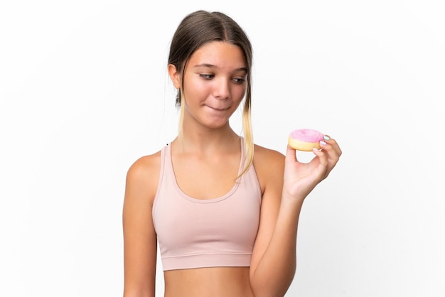 Little caucasian girl isolated on white background holding a donut