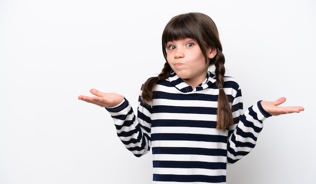 Little caucasian girl isolated on white background making doubts gesture