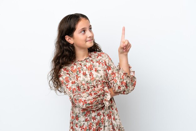 Little caucasian girl isolated on white background pointing up a great idea