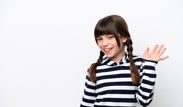 little caucasian girl isolated on white background saluting with hand with happy expression