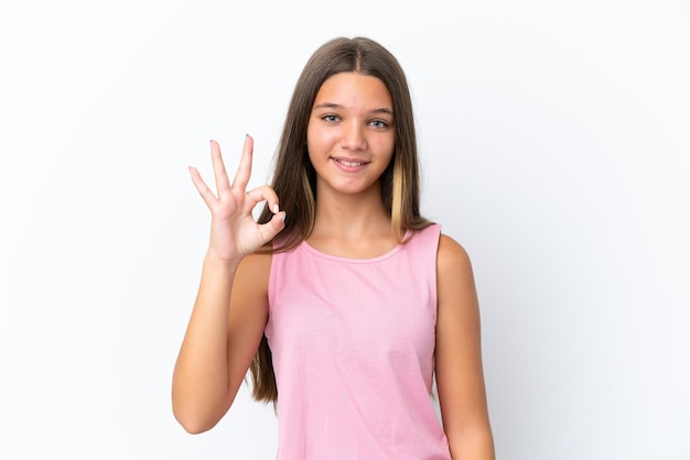 Little caucasian girl isolated on white background showing ok sign with fingers