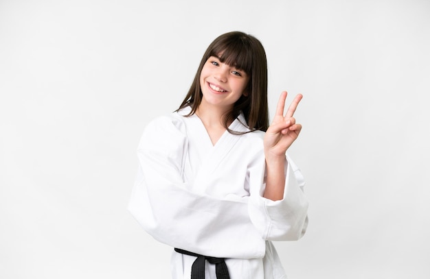Little caucasian girl over isolated white background smiling and showing victory sign