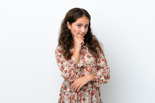 Little caucasian girl isolated on white background and thinking