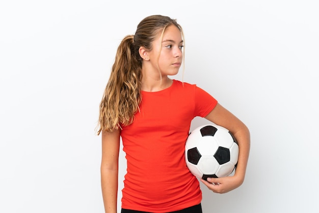 Little caucasian girl isolated on white background with soccer ball