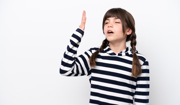 Little caucasian girl isolated on white background with tired and sick expression