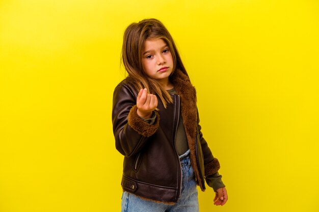 Little caucasian girl isolated on yellow showing that has no money.