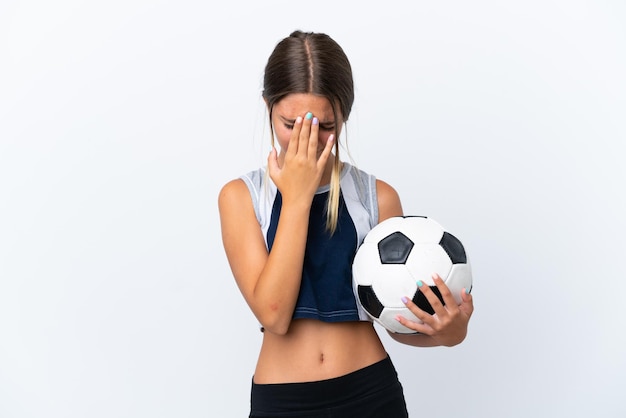 Little caucasian girl playing football isolated on white background with tired and sick expression