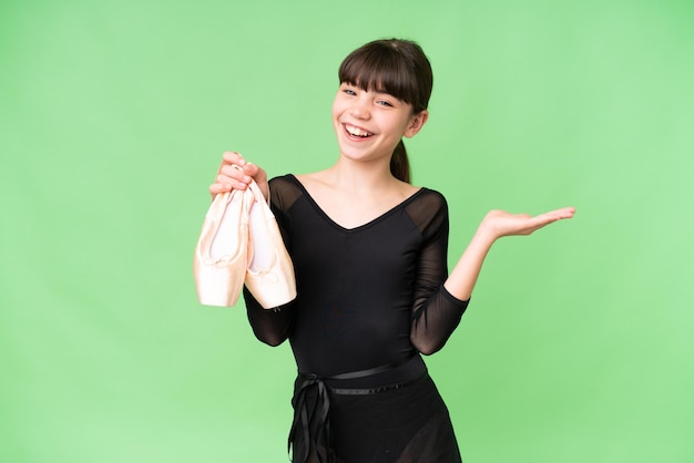 Little caucasian girl practicing ballet over isolated background with shocked facial expression