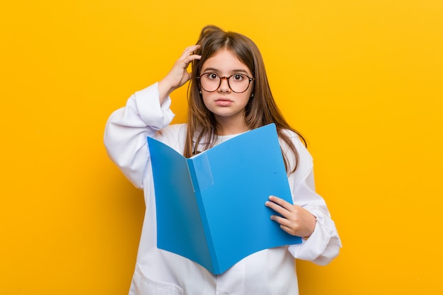 Little caucasian girl wearing a doctor costume being shocked, she has remembered important meeting.