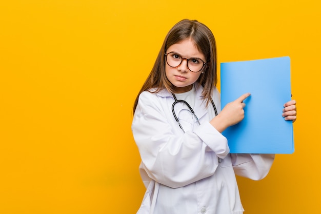 Little caucasian girl wearing a doctor costume