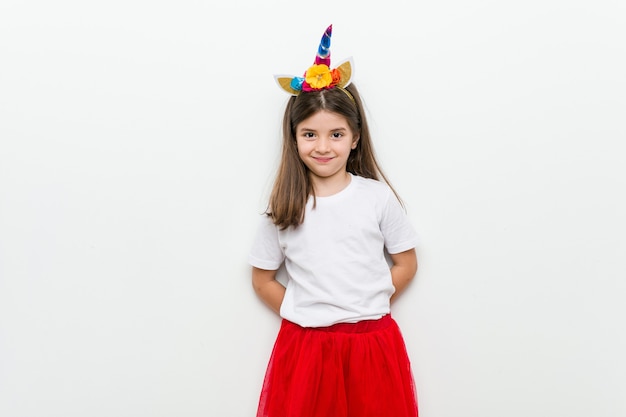 Little caucasian girl with costume and accessories having fun