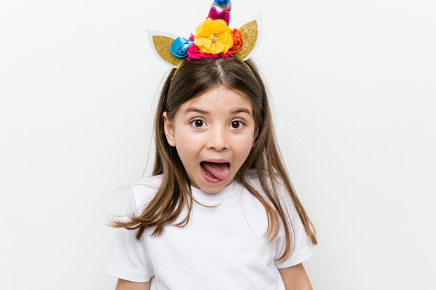 Little caucasian girl with costume and accessories having fun