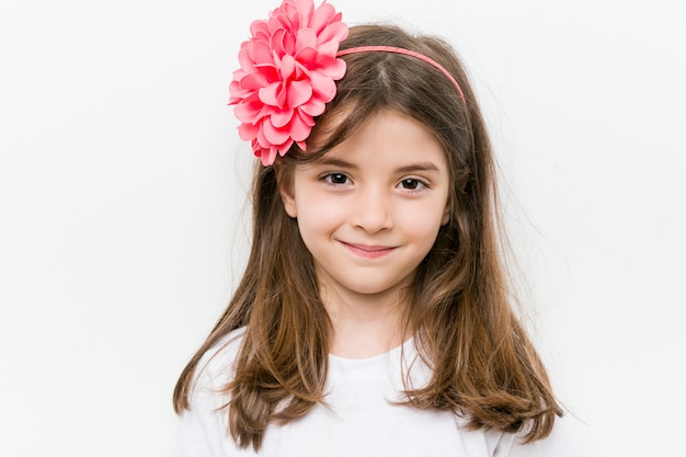 Little caucasian girl with costume and accessories having fun