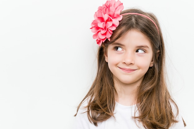 Little caucasian girl with costume and accessories having fun