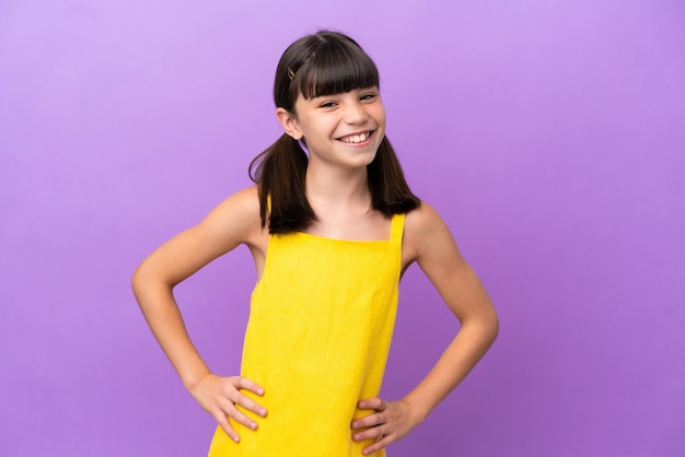 Little caucasian kid isolated on purple background laughing