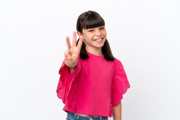 Little caucasian kid isolated on white background happy and counting three with fingers