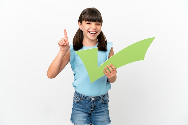 Little caucasian kid isolated on white background holding a check icon and pointing up