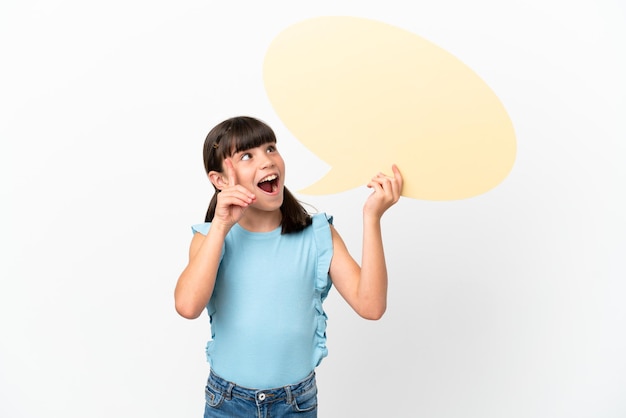 Little caucasian kid isolated on white background holding an empty speech bubble and thinking