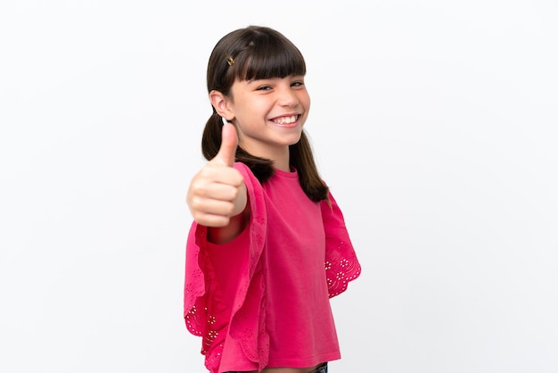 Little caucasian kid isolated on white background with thumbs up because something good has happened